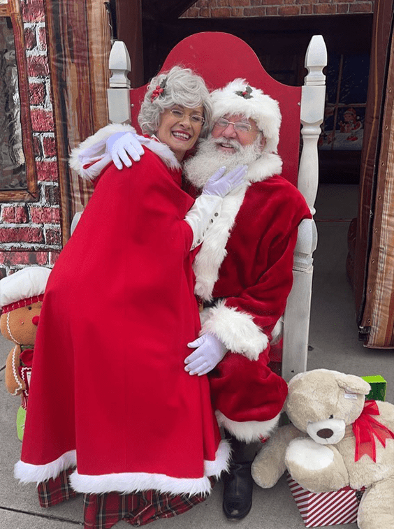 Santa and Mrs. Claus sitting together, smiling.
