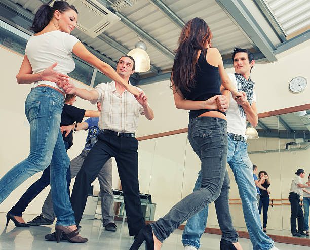 People enjoying a lively dance class indoors.