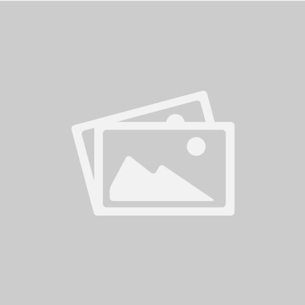 A woman sitting on a park bench holding a bunch of colorful balloons.