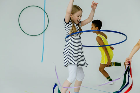 Children playing with hula hoops and ribbons